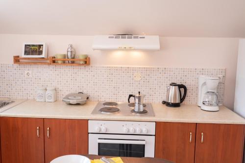a kitchen with a stove and a sink at Christina's place in Sami