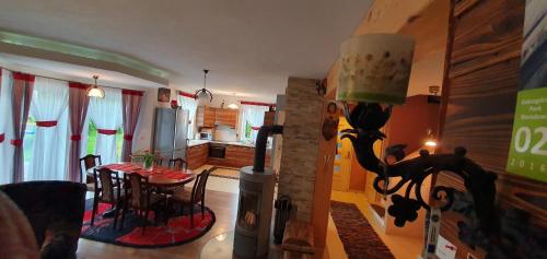 a living room with a dining table and a kitchen at Agroturystyka na Słonecznej Orawie u Dzikich in Jabłonka