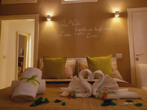 un dormitorio con cisnes hechos de toallas en una cama en Antica Trani, en Trani