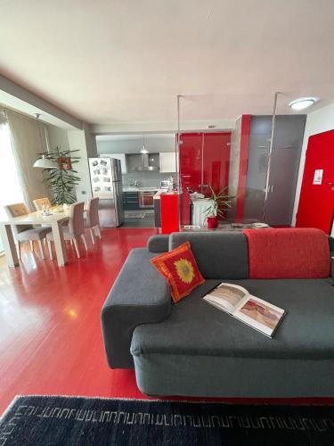 a living room with a couch and a kitchen at Metro Suites in Tirana