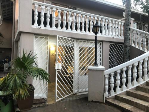 a staircase leading to a house with a gate at Impunzi Place in Kloof