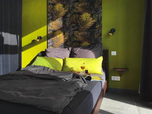 a bedroom with a bed with a green wall at CANARIO in Las Indias