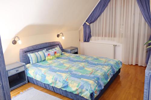 バラトンサールソーにあるLuxusvilla Balatonszárszóの青い掛け布団が敷かれたベッドのある寝室