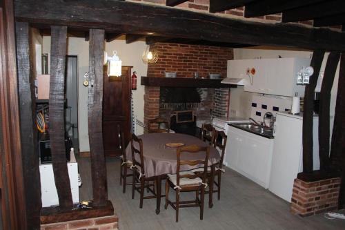 eine Küche und ein Esszimmer mit einem Tisch und Stühlen in der Unterkunft Le Caux'gîte in Bretteville-du-Grand Caux