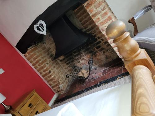 an overhead view of a fireplace in a bedroom at The Flying Horse in Ashford