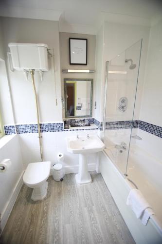 a bathroom with a sink and a toilet and a shower at Mercure Gloucester Bowden Hall Hotel in Gloucester