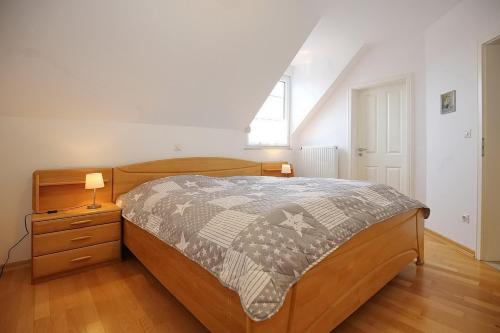 a bedroom with a bed and a night stand with a lamp at Sanddornweg Wohnung 13 b in Boltenhagen