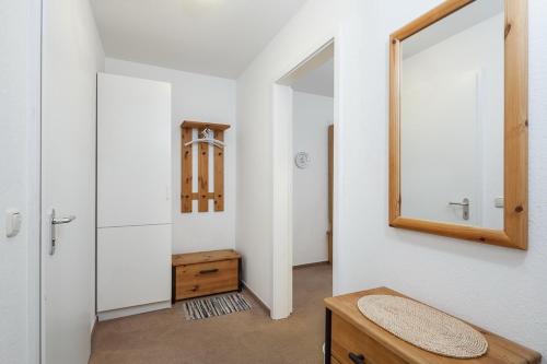 a bathroom with a mirror and a wooden table at Dünenblick Wohnung 11 in Boltenhagen