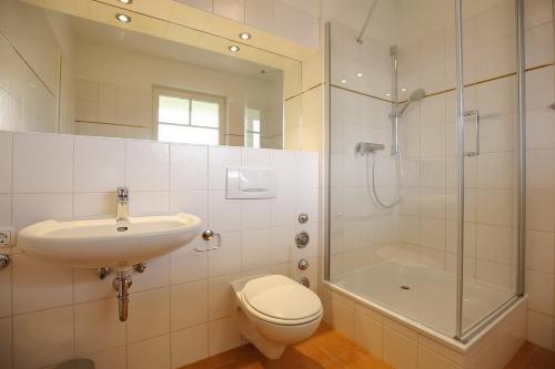 a bathroom with a toilet and a sink and a shower at Likedeeler II Wohnung 04 in Boltenhagen