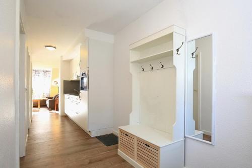 a kitchen with white walls and a white closet at Papillon Wohnung 16-7 in Boltenhagen