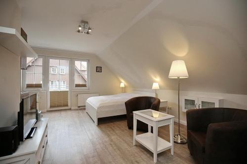 ein Schlafzimmer mit einem Bett und ein Wohnzimmer in der Unterkunft Strandvilla Krabbe Wohnung 13 in Boltenhagen