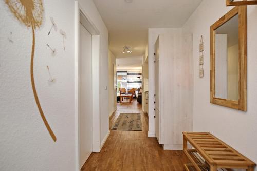 a hallway of a home with white walls and wooden floors at Papillon Wohnung 04-1 in Boltenhagen