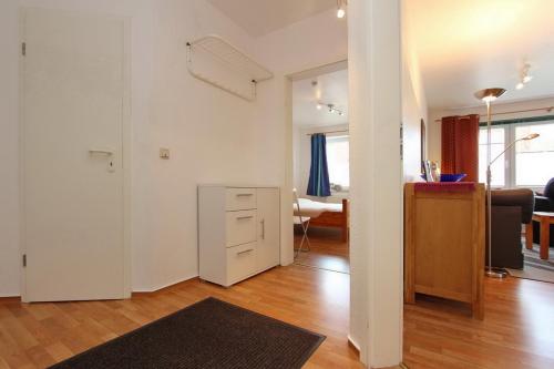 an open living room with a kitchen and a living room at Goosbrink Wohnung 14 in Boltenhagen