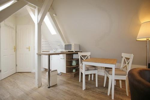 a living room with a table and a table and chairs at Strandvilla Krabbe Wohnung 07 in Boltenhagen