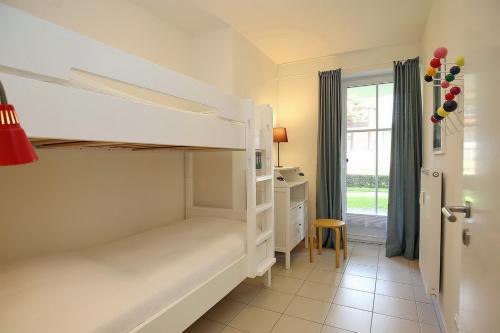 a bedroom with a bunk bed and a desk at Strandvilla Niklot Wohnung 04 in Boltenhagen