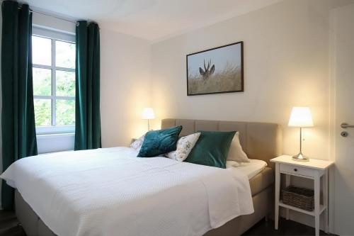 a bedroom with a bed and a window at Residenz von Flotow Wohnung 04 in Heiligendamm