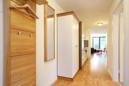 a hallway with a closet and a door with a mirror at Papillon Wohnung 04-4 in Boltenhagen