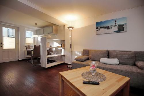 a living room with a couch and a table at Strandvilla Krabbe Wohnung 01 in Boltenhagen