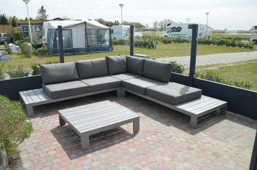 a couch and a coffee table on a patio at 17e straatje in Elburg