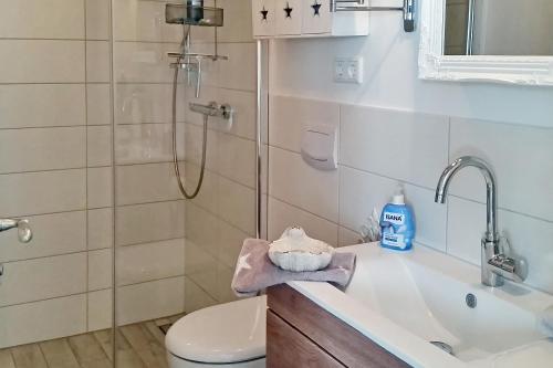 a bathroom with a shower and a sink and a toilet at Linden-Palais Wohnung 12 in Heiligendamm