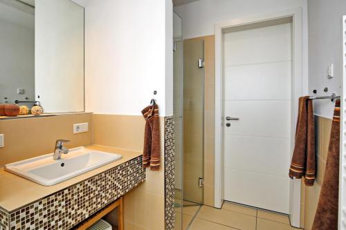 a bathroom with a sink and a shower at Villa Sanddorn Wohnung 16 in Börgerende-Rethwisch