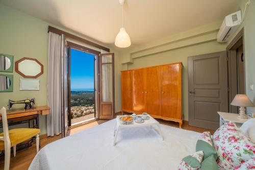 a living room with a table and a large window at Saint George Castle Villa with sea view in Kefallonia