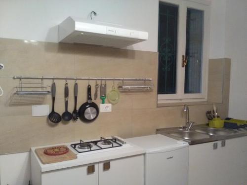 a kitchen with a white stove and a sink at VILLA MONICA Diano San Pietro (IM) Italy in Diano San Pietro