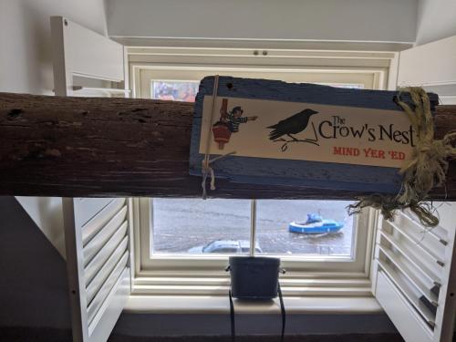 a sign is hanging in front of a window at Whitby Sea View Cottage in Whitby