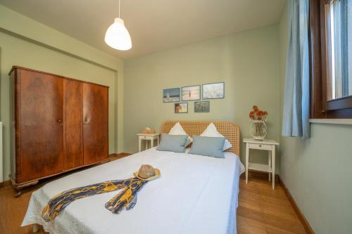 a bedroom with a large white bed with a wooden headboard at Saint George Castle Villa with sea view in Kefallonia