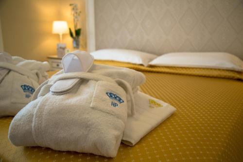 a pile of towels on the floor of a hotel room at Hotel Terme Principe in Abano Terme