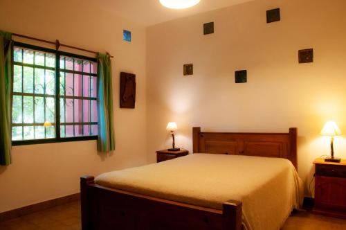 1 dormitorio con cama y ventana en Cabañas Nueve Lunas en Santa Rosa de Calamuchita