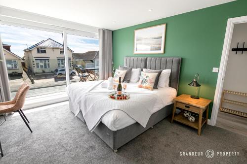 a bedroom with a large bed and a large window at BOURNECOAST - STYLISH FLAT with SEA GLIMPSES - FM8406 in Bournemouth