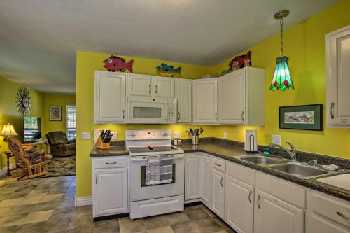 a kitchen with white cabinets and a stove top oven at Cloud 9 On The Coast Less Than 1 Mi to Beach! in Waveland