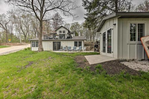 a house with a porch and a house at Big Cedar Lake House Views, 100 Ft to Water! in Hartford
