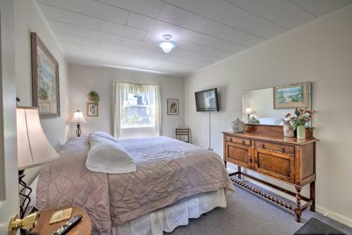 a bedroom with a bed and a wooden dresser at Rockaway Beach Escape with View Steps to Sand! in Rockaway Beach