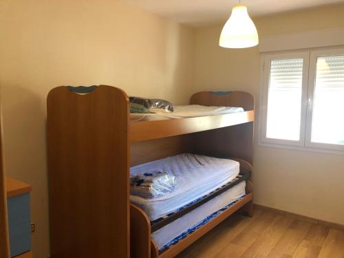 a room with two bunk beds and a window at Tortugas 16 in Carboneras