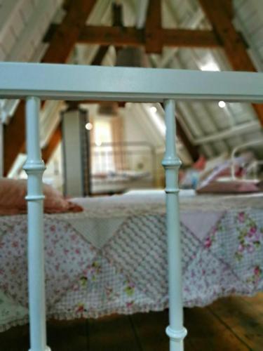 a bed with a white rail in a room at Old Bruges B&B in Bruges