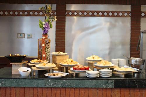 a buffet with plates of food on a table at Hotel Las Americas in Guatemala