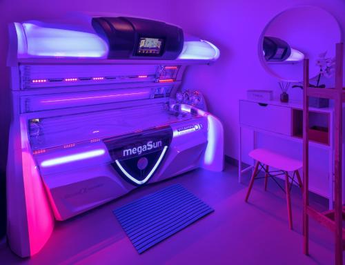 a purple room with a dresser and a bed with a stool at ARMEX LiveCentrum in Děčín