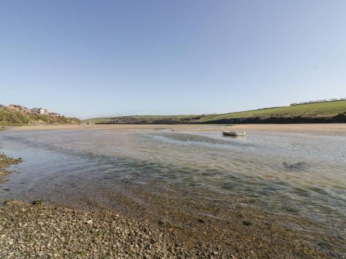 a beach with a boat in the water at Crabs and Lobsters in Newquay