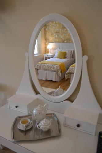 a bedroom with a bed and a mirror on a table at La Locanda nel Frutteto in Rovereto