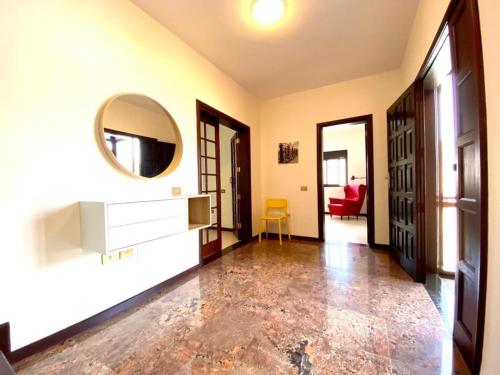 a living room with a mirror and a red chair at Vivienda Vacacional Villa El Mirador in San Sebastián de la Gomera