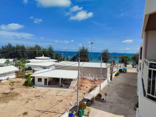 an overhead view of a building with the ocean in the background at Grand Beach 2, apartment by Wheelie75 in Ban Tha Fat