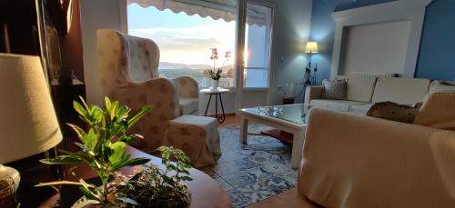 a living room with a couch and a table at Villa Santa Mavra in Glinado Naxos