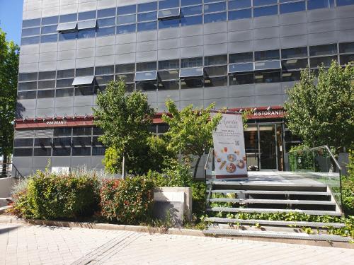 a building with a sign in front of it at Bonito Apto Cinco Torres Plaza Castilla in Madrid