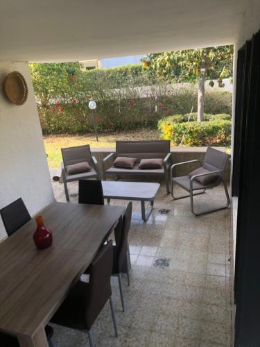 a patio with tables and chairs and a table and chairs at Villa Mariapia in Fontane Bianche