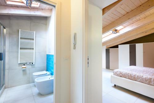 a bathroom with a bed and a toilet and a sink at Casa Tafuri in Santa Maria di Castellabate