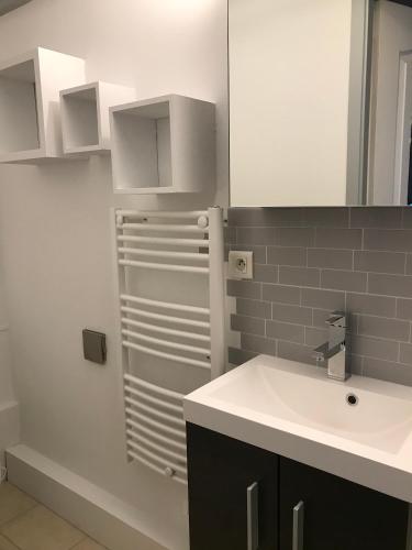 une salle de bain avec un lavabo et un réfrigérateur dans l'établissement L'échoppe Rochelaise, à La Rochelle