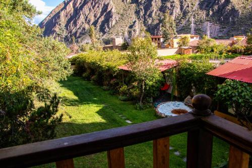 a view of a yard with a mountain in the background at Hotel Samanapaq in Ollantaytambo