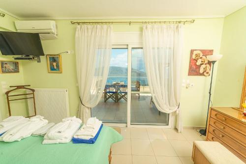 a bedroom with a bed and a view of the ocean at Skroponeria View Apartments in Skroponeria